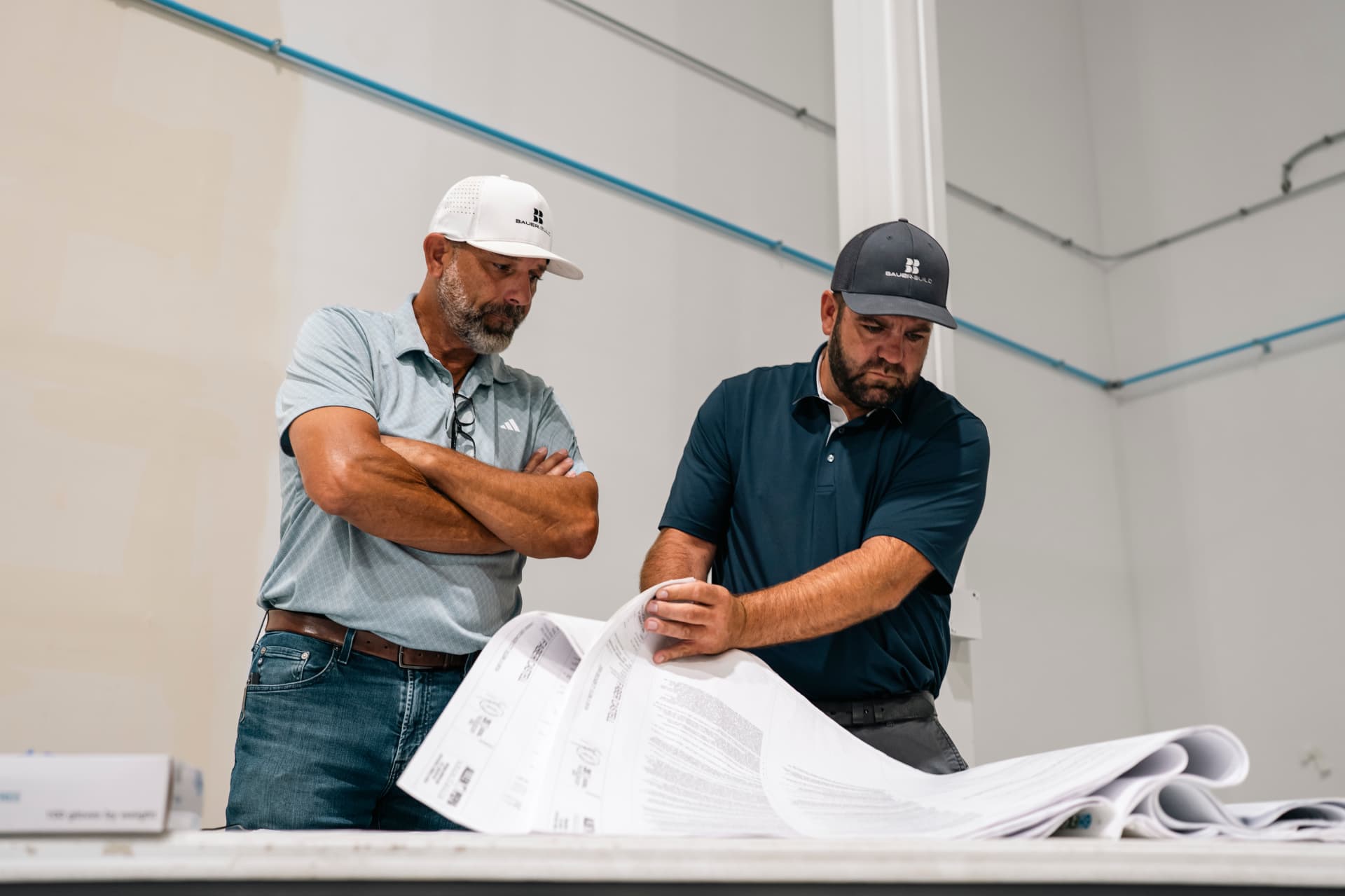 Bauer-Build team reviewing construction plans on site